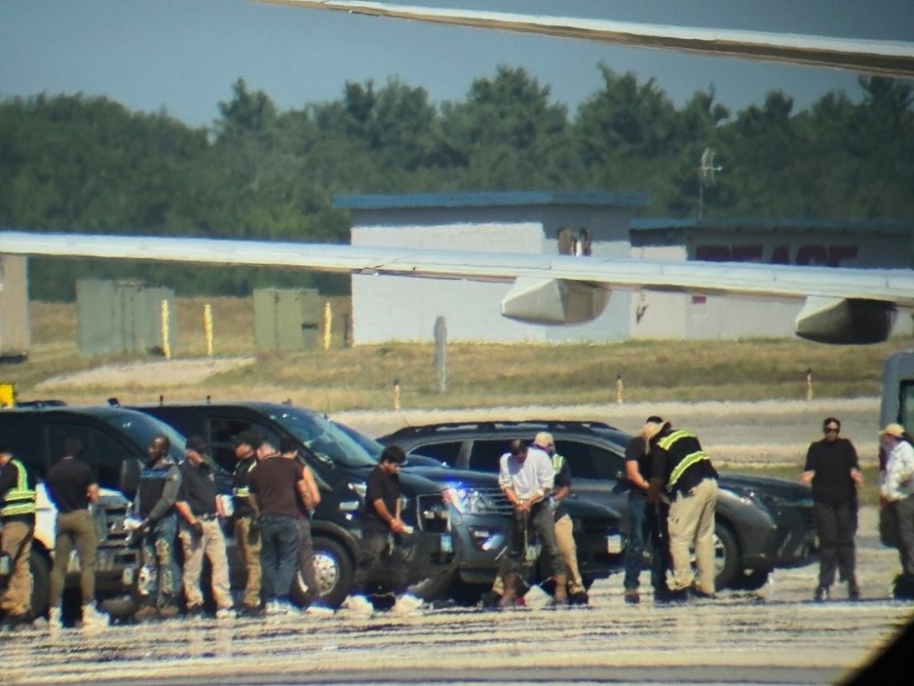 In this photo obtained by the Associated Press, ICE detainees line up to board a flight at Portsmouth International Airport at Pease, N.H., on Saturday, Aug. 16, 2025. (AP Photo)