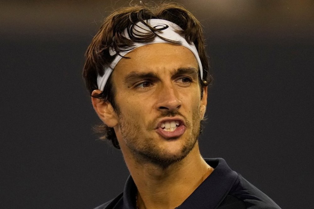 Lorenzo Musetti of Italy reacts during play against Giovanni Mpetshi Perricard of France in a men's singles match for the China Open tennis tournament in Beijing, China, Friday, Sept. 26, 2025. (AP Photo/Ng Han Guan)