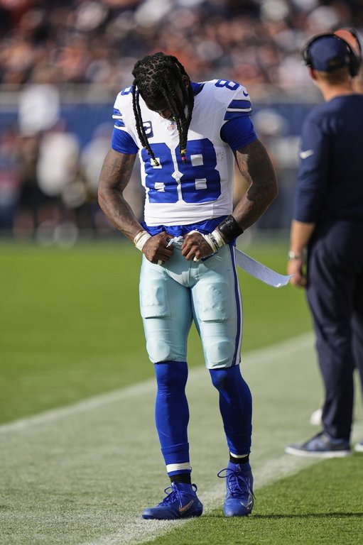 Dallas Cowboys wide receiver CeeDee Lamb walks along the sideline after suffering an unknown injury in the first half of an NFL football game against the Chicago Bears Sunday, Sept. 21, 2025, in Chicago. (AP Photo/Erin Hooley)