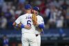 Texas Rangers third baseman Josh Jung (6) and first base Jake Burger react after a baseball game against the Milwaukee Brewers Wednesday, Sept. 10, 2025, in Arlington, Texas. (AP Photo/Julio Cortez)
