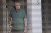 Brazil's former President Jair Bolsonaro stands at the entrance of his home where he is under house arrest in Brasilia, Brazil, Thursday, Sept. 11, 2025. (AP Photo/Luis Nova)