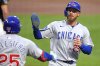 Chicago Cubs' Michael Busch (29) is greeted by Moisés Ballesteros as he returns to the dugout after scoring on a sacrifice fly by Ian Happ off Pittsburgh Pirates pitcher Paul Skenes during the second inning of a baseball game in Pittsburgh, Tuesday, Sept. 16, 2025. (AP Photo/Gene J. Puskar)