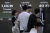 Currency traders work near a screen showing the Korea Composite Stock Price Index (KOSPI), top left, at the foreign exchange dealing room of the Hana Bank headquarters in Seoul, South Korea, Tuesday, Sept. 16, 2025. (AP Photo/Ahn Young-joon)