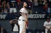 Cleveland Guardians' Austin Hedges reacts after being called out on strikes from Texas Rangers starting pitcher Jacob Latz to end the fifth inning of a baseball game, Saturday, Sept. 27, 2025, in Cleveland. (AP Photo/Phil Long)