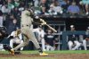 San Diego Padres' Ryan O'Hearn (32) hits a three-run double against the Chicago White Sox during the sixth inning of a baseball game, Saturday, Sept. 20, 2025, in Chicago. (AP Photo/Kamil Krzaczynski)
