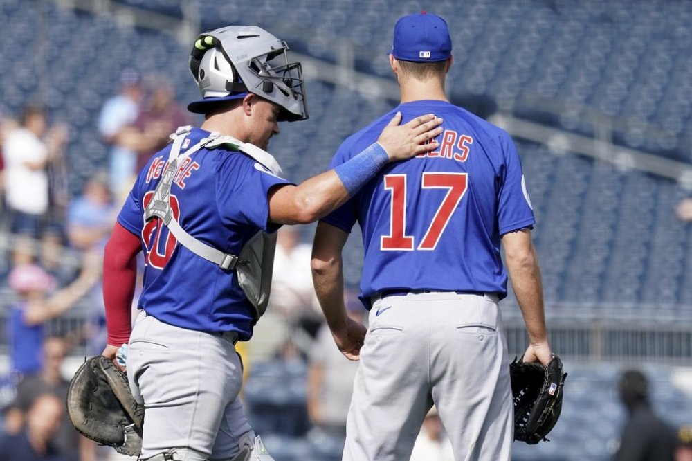 Chicago Cubs pitcher Taylor Rogers, right, celebrates with catcher Reese McGuire, left, after getting the final out of a baseball game against the Pittsburgh Pirates Wednesday, Sept. 17, 2025, in Pittsburgh. (AP Photo/Matt Freed)