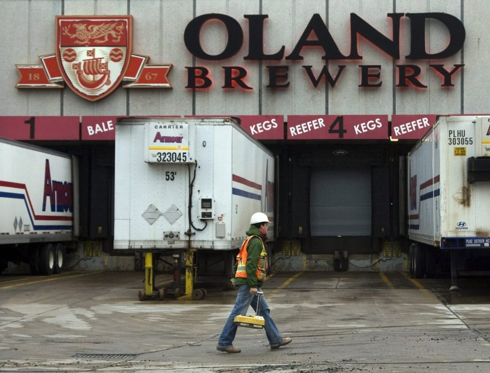 A worker crosses the parking lot of the Oland Brewery in Halifax on Tuesday, Nov. 23, 2010. THE CANADIAN PRESS/Andrew Vaughan