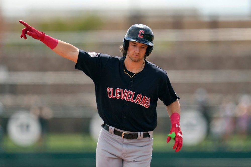 FILE - Cleveland Guardians' Chase DeLauter points as he rounds the bases after hitting a three-run home run against the Chicago White Sox during the first inning of a spring training baseball game, March 18, 2024, in Phoenix. (AP Photo/Ross D. Franklin, file)