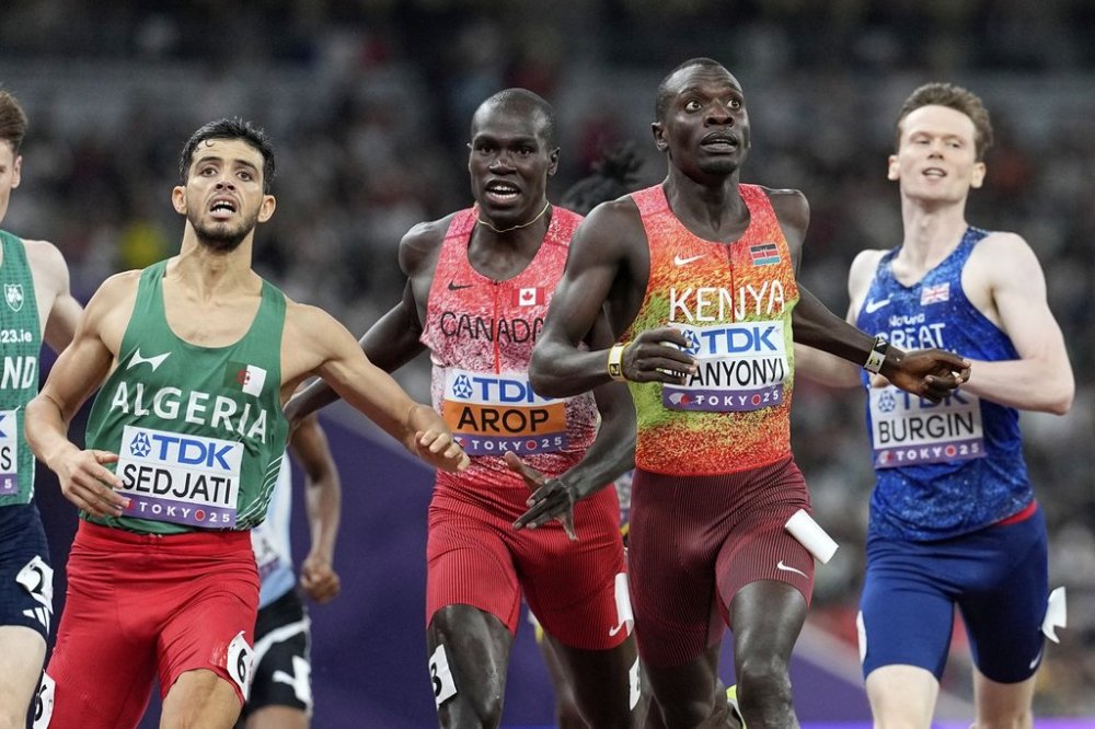 Kenya's Emmanuel Wanyonyi, gold, Algeria's Djamel Sedjati, silver, and Canada's Marco Arop, bronze, cross the line after the men's 800-metre final at the world athletics championships in Tokyo, Saturday, Sept. 20, 2025. (AP Photo/Petr David Josek)