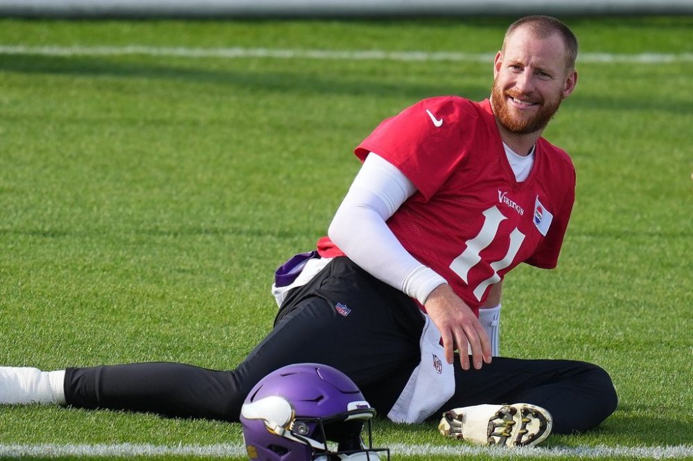 Minnesota Vikings quarterback Carson Wentz (11) stretches during NFL football practice at Hanbury Manor in Ware, England, Wednesday, Oct. 1, 2025. The Vikings play the Cleveland Browns in London on Sunday. (AP Photo/Kirsty Wigglesworth)