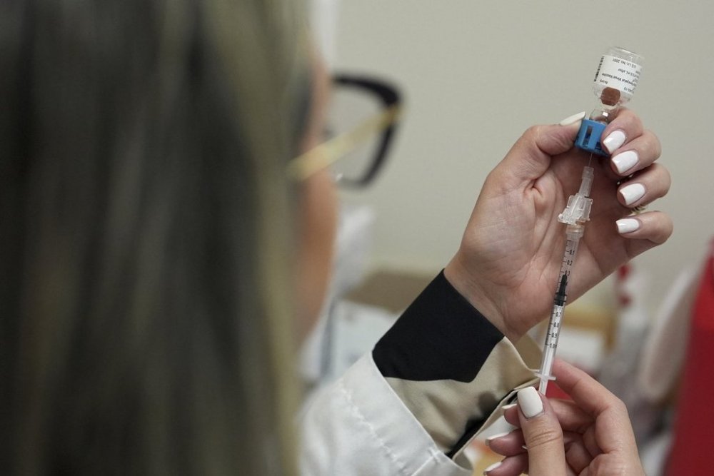 Pharmacy manager Aylen Amestoy draws a dose of respiratory syncytial virus (RSV) vaccine into a syringe as she prepares a shot for a patient at a CVS Pharmacy in Miami, Tuesday, Sept. 9, 2025. (AP Photo/Rebecca Blackwell)