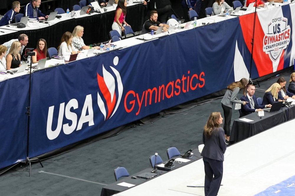 FILE - Signage showing the new USA Gymnastics logo is displayed during the 2022 U.S. Gymnastics Championships, Friday, Aug. 19, 2022, in Tampa, Fla.(AP Photo/Mike Carlson, file)
