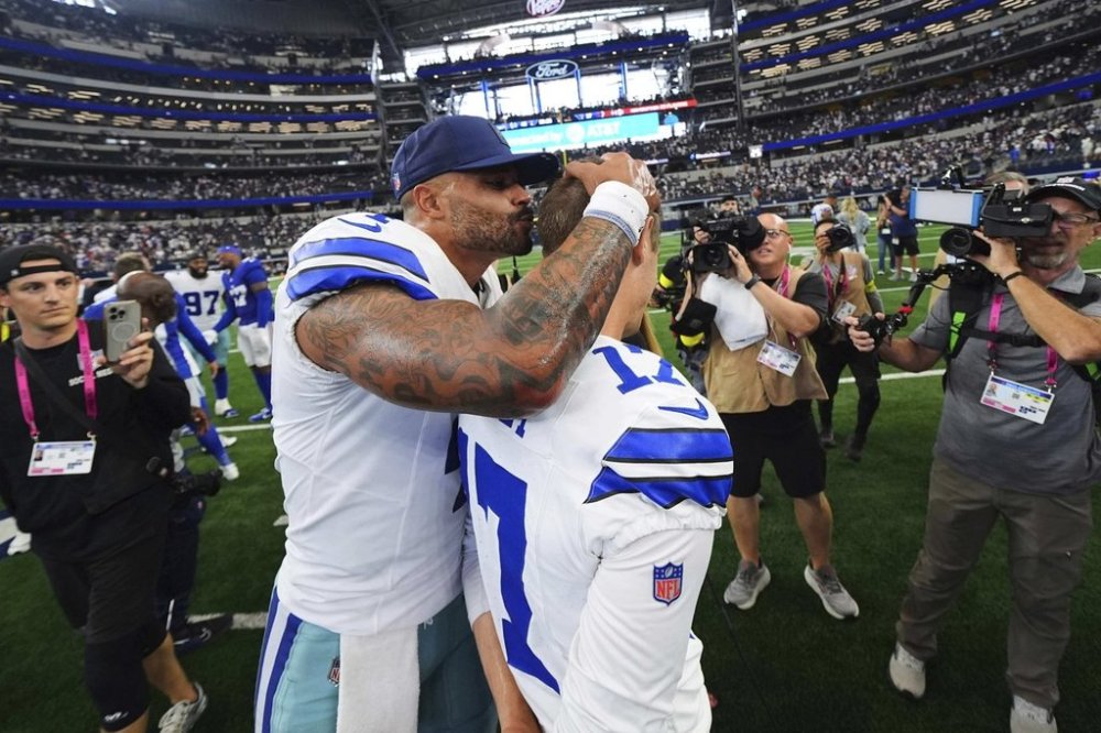 Dallas Cowboys quarterback Dak Prescott (4) gives place kicker Brandon Aubrey, right, a kiss on the head after the team's overtime win in an NFL football game against the New York Giants Sunday, Sept. 14, 2025, in Arlington, Texas. (AP Photo/Julio Cortez)