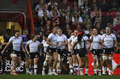 Canada's team players celebrate after scoring their first try during the Women's Rugby World Cup 2025 semifinal match between New Zealand and Canada in Bristol, England, Friday, Sept. 19, 2025. (AP Photo/Anthony Upton)