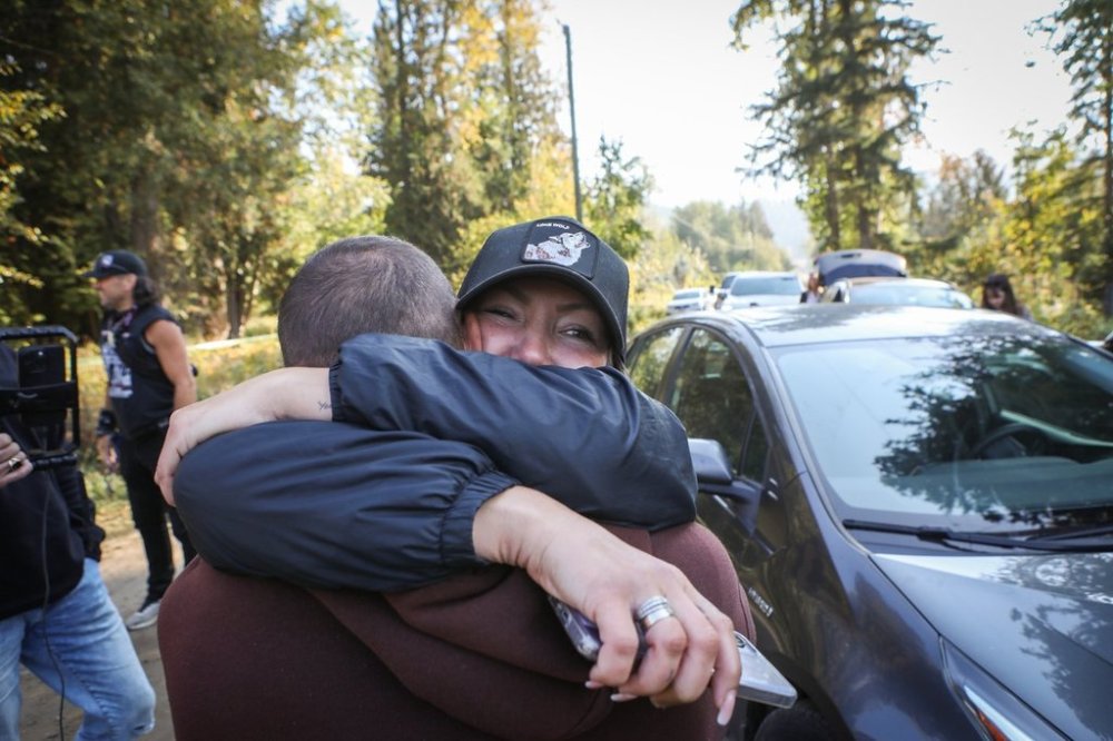 Katie Pasitney, the daughter of one of the owners of the Universal Ostrich Farms in Edgewood, B.C., celebrates with a supporter after learning that an interim stay order was granted by the Supreme Court of Canada on Wednesday, Sept. 24, 2025, delaying the culling of 400 of the farm’s ostriches. THE CANADIAN PRESS/Aaron Hemens