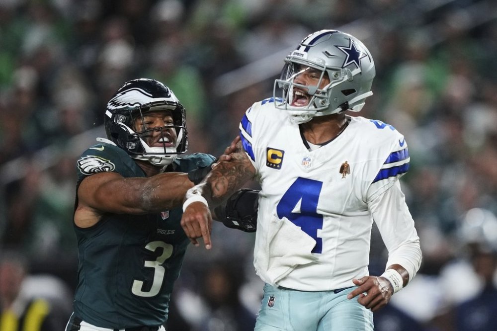 Dallas Cowboys quarterback Dak Prescott (4) releases a pass under pressure from Philadelphia Eagles linebacker Nolan Smith Jr. (3) in the second half of an NFL football game Thursday, Sept. 4, 2025, in Philadelphia. (AP Photo/Matt Slocum)