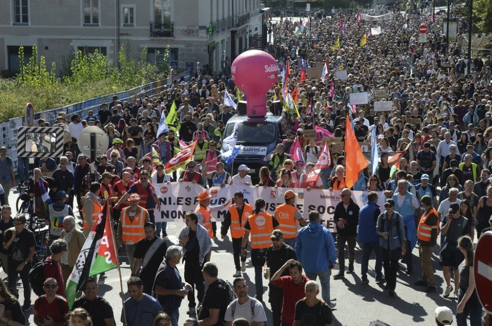 Demonstrators march during a protest called by major trade unions to oppose budget cuts, in Nantes, western France, Thursday, Sept. 18, 2025. (AP Photo/Mathieu Pattier)