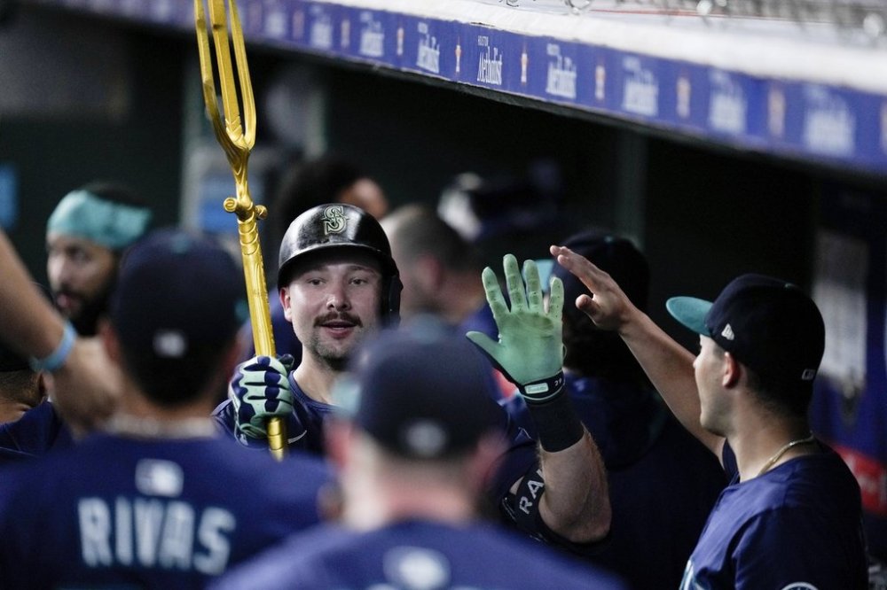 Seattle Mariners' Cal Raleigh carries a trident after hitting a solo home run, his 57th of the season, against the Houston Astros during the third inning of a baseball game Saturday, Sept. 20, 2025, in Houston. (AP Photo/Eric Christian Smith)