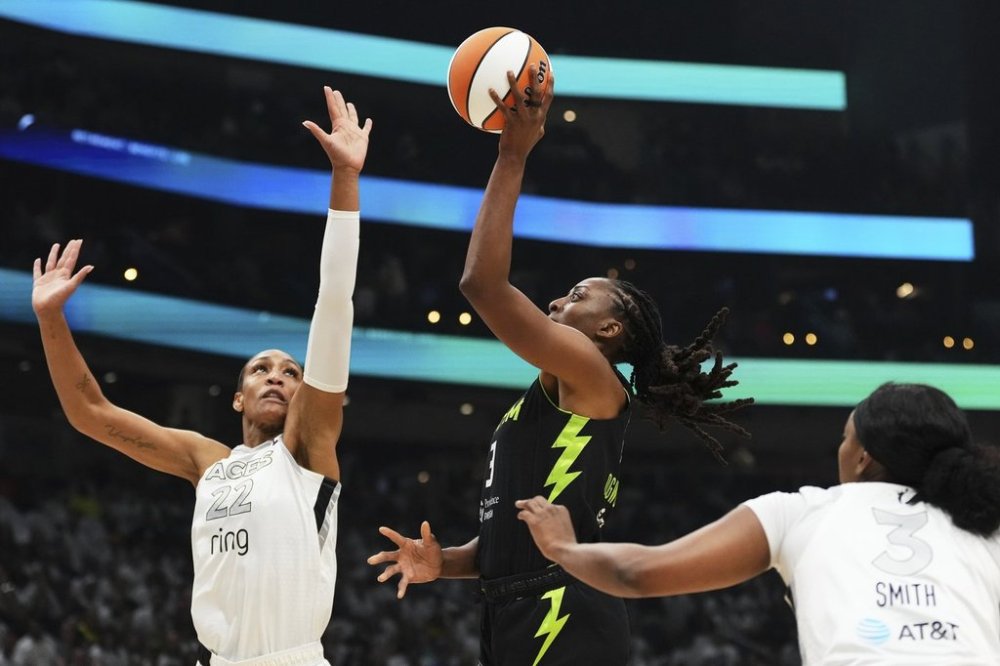 Seattle Storm forward Nneka Ogwumike, center, goes to the basket against Las Vegas Aces center A'ja Wilson (22) and forward NaLyssa Smith (3) during the first half of Game 2 in the first round of the WNBA basketball playoffs Tuesday, Sept. 16, 2025, in Seattle. (AP Photo/Lindsey Wasson)