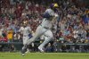 Milwaukee Brewers' Brice Turang, right, singles as Jackson Chourio, left, jogs in to score during the 10th inning of a baseball game against the St. Louis Cardinals Saturday, Sept. 20, 2025, in St. Louis. (AP Photo/Jeff Roberson)