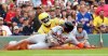 Detroit Tigers' Javier Báez (28) slides safely into home plate as Boston Red Sox catcher Carlos Narváez attempts the out during the fifth inning of a baseball game, Saturday, Sept. 27, 2025, in Boston. (AP Photo/Mark Stockwell)