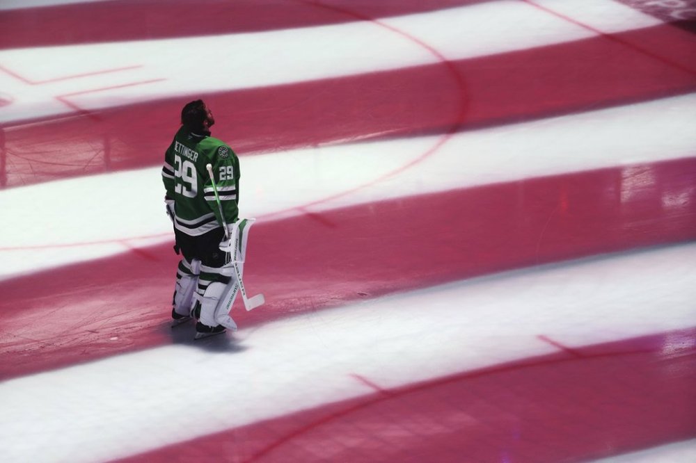 FILE - Dallas Stars goaltender Jake Oettinger (29) stands as the national anthem plays before Game 5 of the Western Conference finals in the NHL hockey Stanley Cup playoffs against the Edmonton Oilers, Thursday, May 29, 2025, in Dallas. (AP Photo/Gareth Patterson, File)