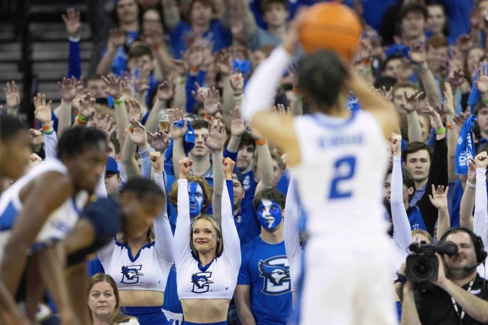 FILE - Creighton cheerleaders and fans raise their hands as Creighton's Ryan Nembhard (2) takes free throws against Marquette during the first half of an NCAA college basketball game Feb. 21, 2023, in Omaha, Neb. (AP Photo/Rebecca S. Gratz, File)