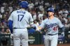 Los Angeles Dodgers' Ben Rortvedt celebrates with Shohei Ohtani (17) after hitting a solo home run against the Arizona Diamondbacks in the seventh inning of a baseball game, Tuesday, Sept. 23, 2025, in Phoenix. (AP Photo/Rick Scuteri)