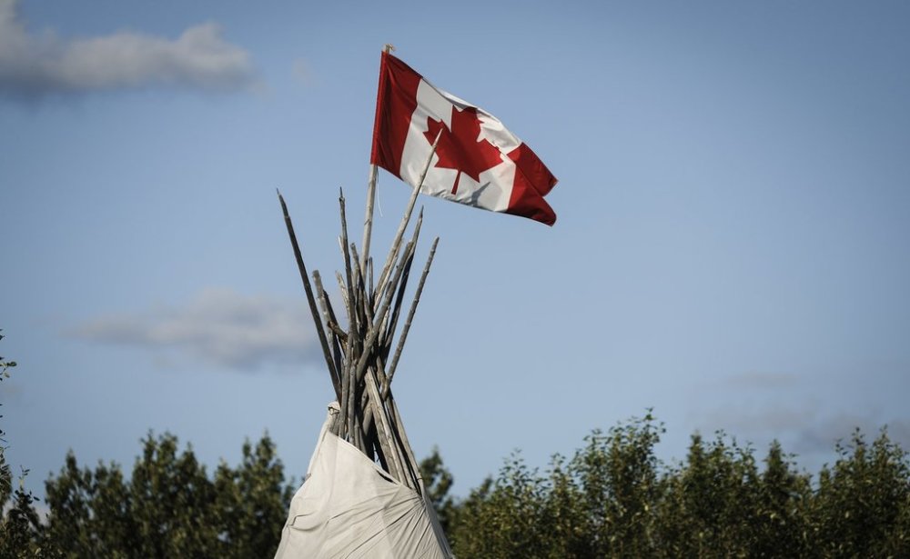 A Canadian flag flies from the top of a teepee in Fort Smith, N.W.T, on Tuesday, July 22, 2025. THE CANADIAN PRESS/Jeff McIntosh