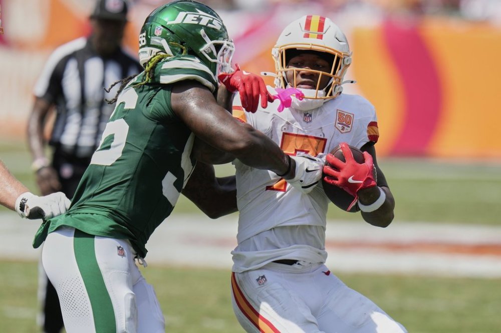 New York Jets linebacker Quincy Williams (56) tackles Tampa Bay Buccaneers running back Bucky Irving (7) during the first half of an NFL football game Sunday, Sept. 21, 2025, in Tampa, Fla. (AP Photo/Chris O'Meara)