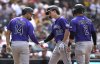Colorado Rockies' Mickey Moniak (22) is congratulated by Tyler Freeman (2) and Ezequiel Tovar (14) after hitting a three-run home run against the San Diego Padres during the sixth inning of a baseball game Sunday, Sept. 14, 2025, in San Diego. (AP Photo/Orlando Ramirez)