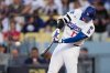 Los Angeles Dodgers' Shohei Ohtani connects for a solo home run during the first inning in Game 1 of the National League Wild Card baseball playoff series against the Cincinnati Reds, Tuesday, Sept. 30, 2025, in Los Angeles. (AP Photo/Mark J. Terrill)