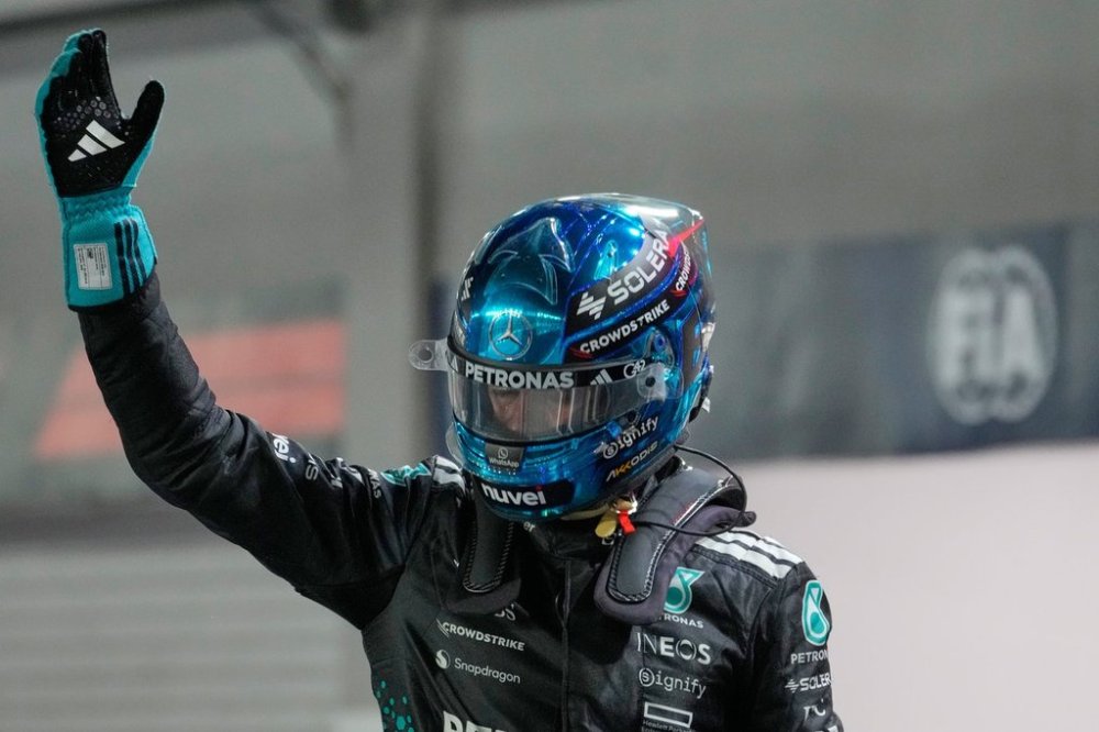 Mercedes driver George Russell of Britaine reacts after taking pole position during the qualifying for the Singapore Formula One Grand Prix at the Marina Bay Street Circuit in Singapore, Saturday, Oct. 4, 2025. (AP Photo/Vincent Thian)