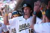 Athletics' Nick Kurtz celebrates in the dugout after hitting a two-run home run during the fifth inning of a baseball game against the Cincinnati Reds, Sunday, Sept. 14, 2025, in West Sacramento, Calif. (AP Photo/Sara Nevis)