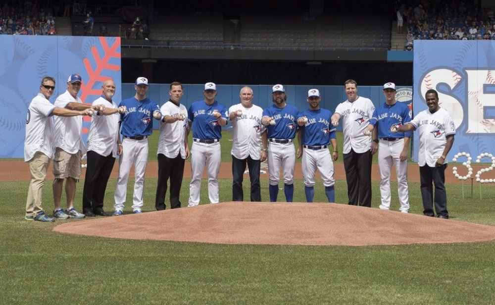 Former and current Blue Jay pitchers Mike Timlin, left to right, Tom Henke, Duane Ward, J.A. Happ, Pat Hentgen, Brett Cecil, Dave Stieb, R.A. Dickey, Marco Estrada, Roy Halladay, Aaron Sanchez and Juan Guzman pose for a photo as part of pre-game ceremonies celebrating the team's 40th anniversary season, prior to the start of the Blue Jays American League MLB baseball game against the Houston Astros in Toronto on Sunday, August 14, 2016. THE CANADIAN PRESS/Fred Thornhill