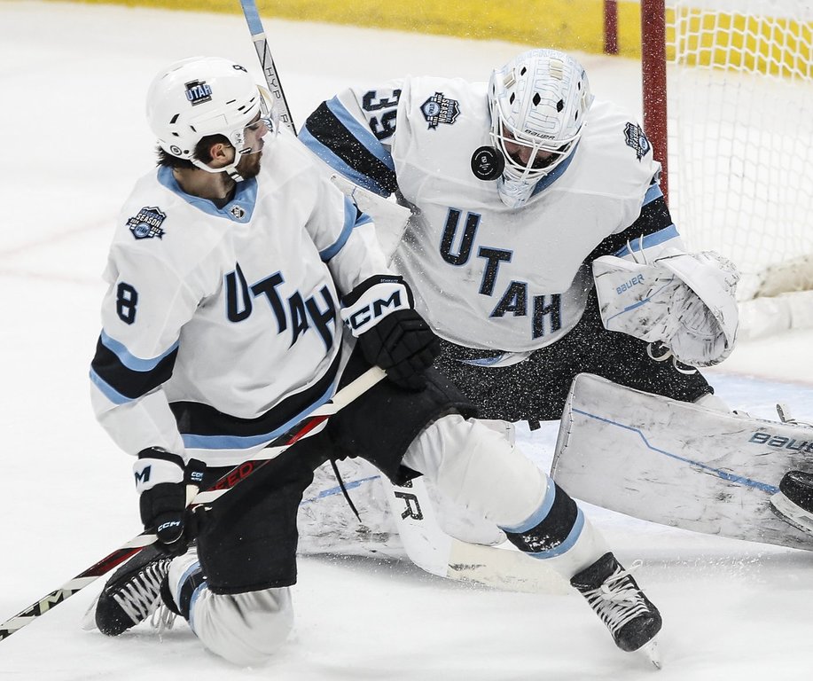 Utah Hockey Club goaltender Connor Ingram (39) saves the shot as Nick Schmaltz (8) defends against the Winnipeg Jets during second period NHL action in Winnipeg on Friday, Jan. 24, 2025. THE CANADIAN PRESS/John Woods