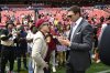 Washington Commanders owenr Josh Harris, right, talks with former NFL quarterback Tom Brady, right, before the start of an NFL football game against the New York Giants, Sunday, Sept. 7, 2025, in Landover, Md. (AP Photo/Nick Wass)