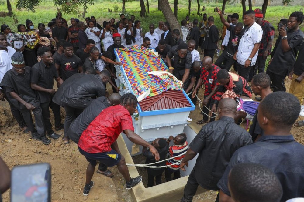 The fantasy coffin of the late Robert Nii Anang Obodai, a former school proprietor, is lowered into his grave in Accra, Ghana, Saturday, July 26, 2025. (AP Photo/Misper Apawu)