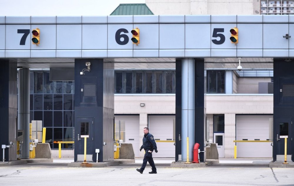 A Canadian Border Services Agency worker is seen at the Canada/USA border crossing in Windsor, Ont. on Saturday, March 21, 2020. THE CANADIAN PRESS/Rob Gurdebeke