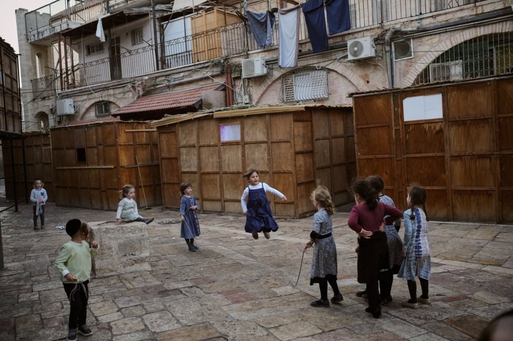 Ultra-Orthodox Jewish children play next to Sukkahs, a temporary structures built for the upcoming Jewish holiday of Sukkot in the Orthodox Jewish neighborhood of Mea Shearim in Jerusalem, Sunday, Oct. 5, 2025. (AP Photo/Ohad Zwigenberg)