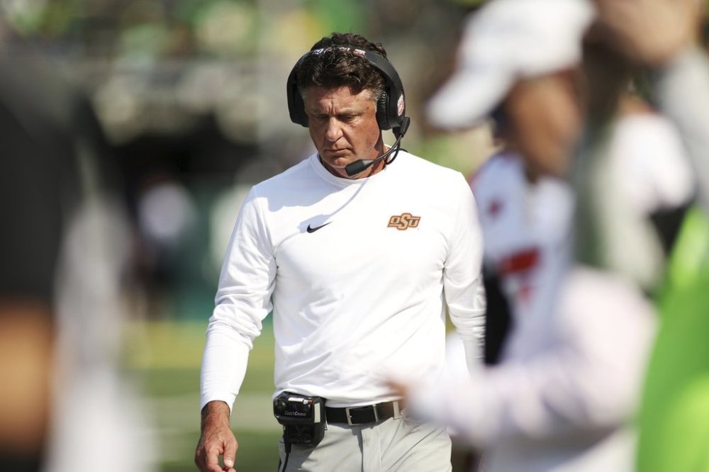 Oklahoma State head coach Mike Gundy walks along the sideline during the second half of an NCAA college football game against Oregon, Saturday, Sept. 6, 2025, in Eugene, Ore. (AP Photo/Lydia Ely)