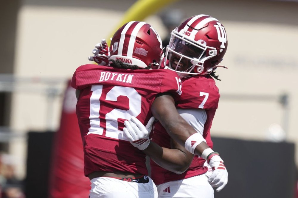 Indiana defensive back Louis Moore (7) celebrates an interception with defensive back Devan Boykin (12) during the second half of an NCAA college football game against Kennesaw State, Saturday, Sept. 6, 2025, in Bloomington, Ind. (AP Photo/Darron Cummings)