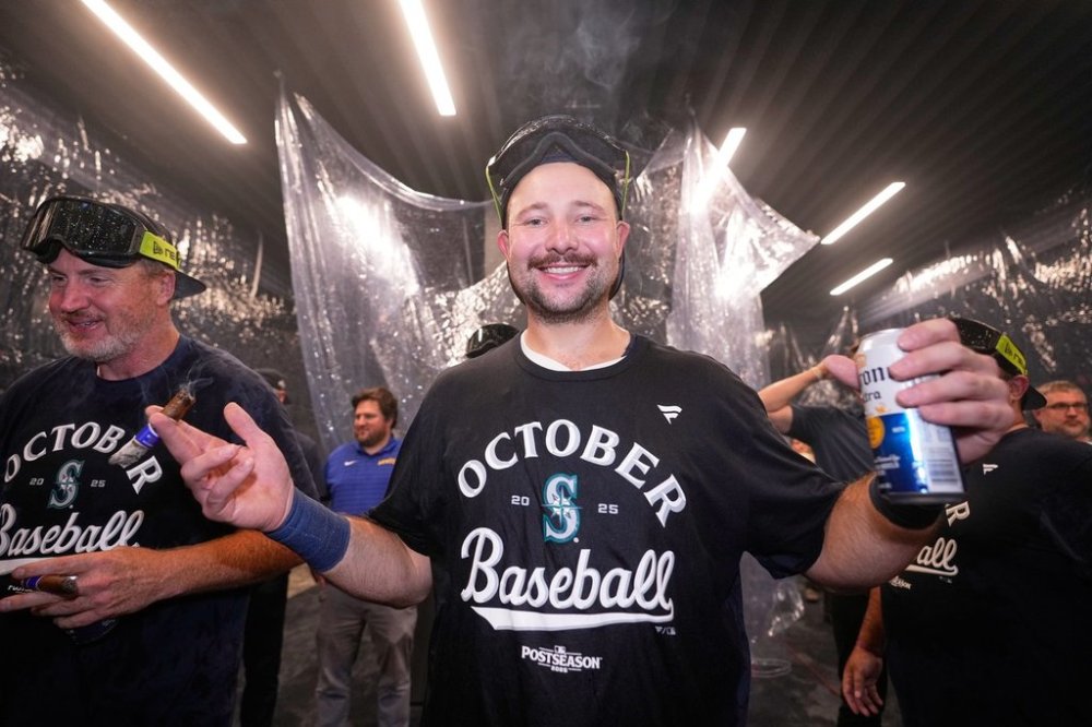 Seattle Mariners catcher Cal Raleigh celebrates after the team's win in a baseball game against the Colorado Rockies to clinch a playoff spot, Tuesday, Sept. 23, 2025, in Seattle. (AP Photo/Ryan Sun)