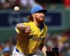 Boston Red Sox pitcher Dustin May throws during the first inning of a baseball game against the Pittsburgh Pirates, Saturday, Aug. 30, 2025, in Boston. (AP Photo/Mark Stockwell)