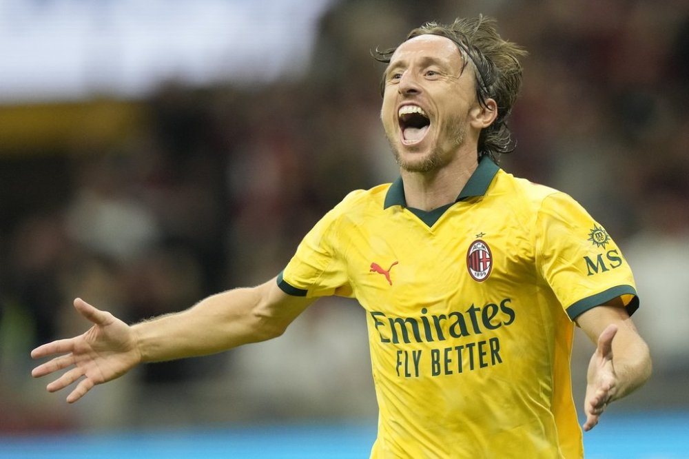 AC Milan's Luka Modric celebrates after scoring his side's opening goal during a Serie A soccer match between AC Milan and Bologna at San Siro stadium in Milan, Italy, Sunday, Sept. 14, 2025. (AP Photo/Luca Bruno)