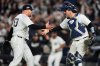 New York Yankees pitcher David Bednar (53) and catcher Austin Wells celebrate after the Yankees beat the Boston Red Sox in Game 3 of an American League wild-card baseball playoff series, Thursday, Oct. 2, 2025, in New York. (AP Photo/Yuki Iwamura)