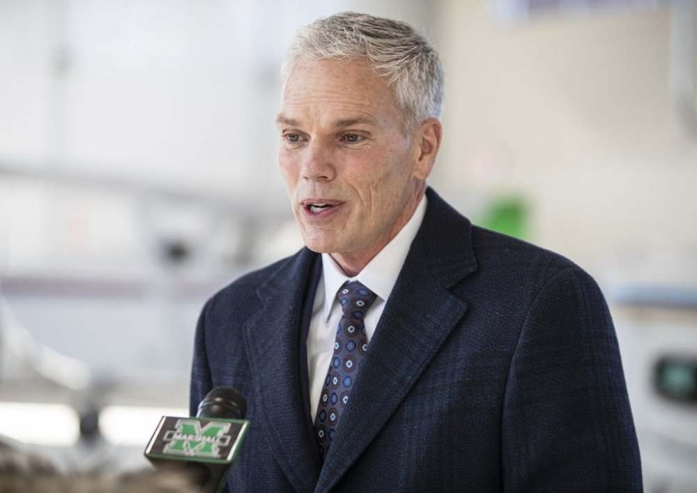 FILE - Marshall University President Brad Smith speaks with members of the media, Jan. 26, 2022, at the Huntington Tri-State Airport, in Huntington, W.Va. (Sholten Singer/The Herald-Dispatch via AP, file)
