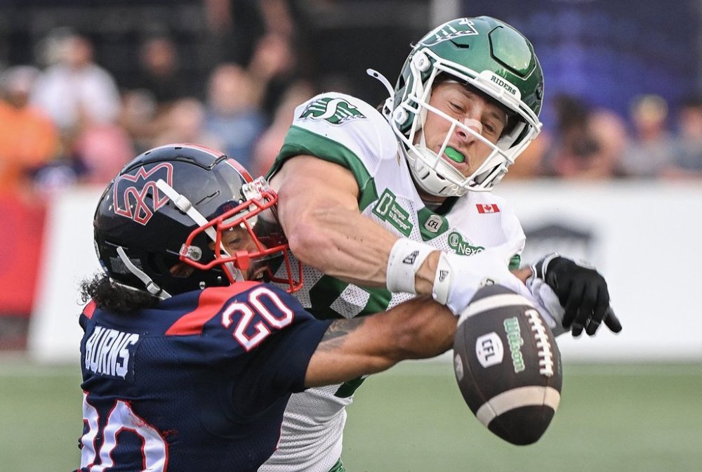 Montreal Alouettes' Lorenzo Burns (20) challenges Saskatchewan Roughriders' Joe Robustelli for the ball during first half CFL football action in Montreal, Saturday, Aug. 2, 2025. THE CANADIAN PRESS/Graham Hughes