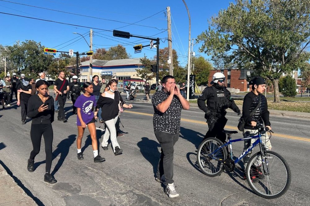 Francisco Fabian Castro, centre, was among those that organized a protest in Longueuil, Que., Sunday, Sept. 28, 2025, to denounce to the fatal shooting of 15-year-old Nooran Rezayi by a Longueuil police officer the week prior. THE CANADIAN PRESS/Miriam Lafontaine