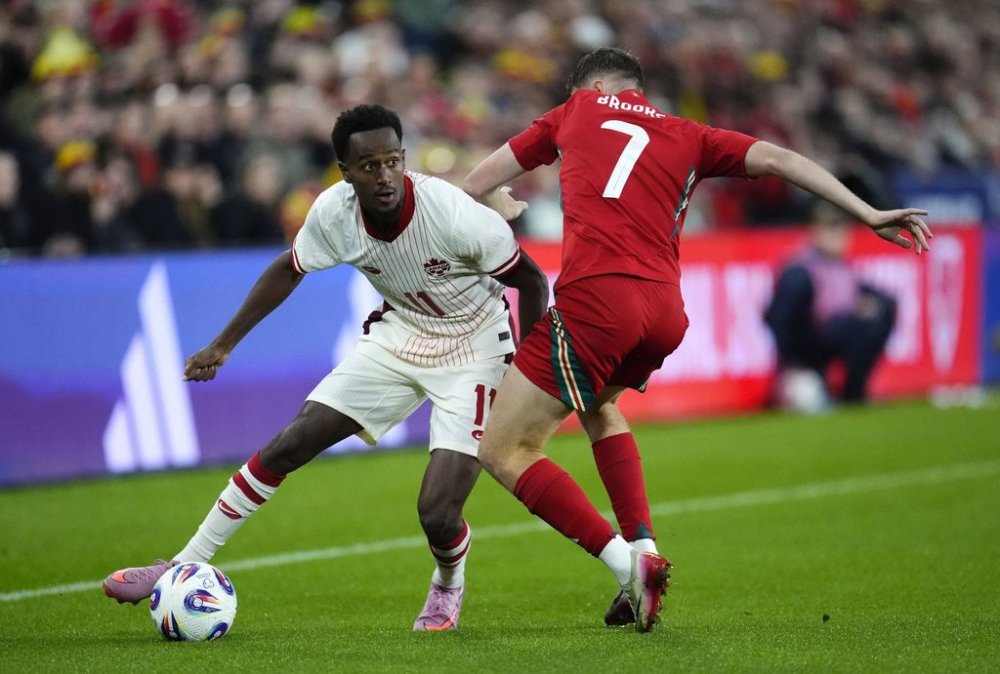 Canada's Ali Ahmed, left, and Wales' David Brooks in action during the international friendly soccer match between Wales and Canada at Swansea.com Stadium, Swansea, Wales, Tuesday Sept. 9, 2025. (Nick Potts/PA via AP)